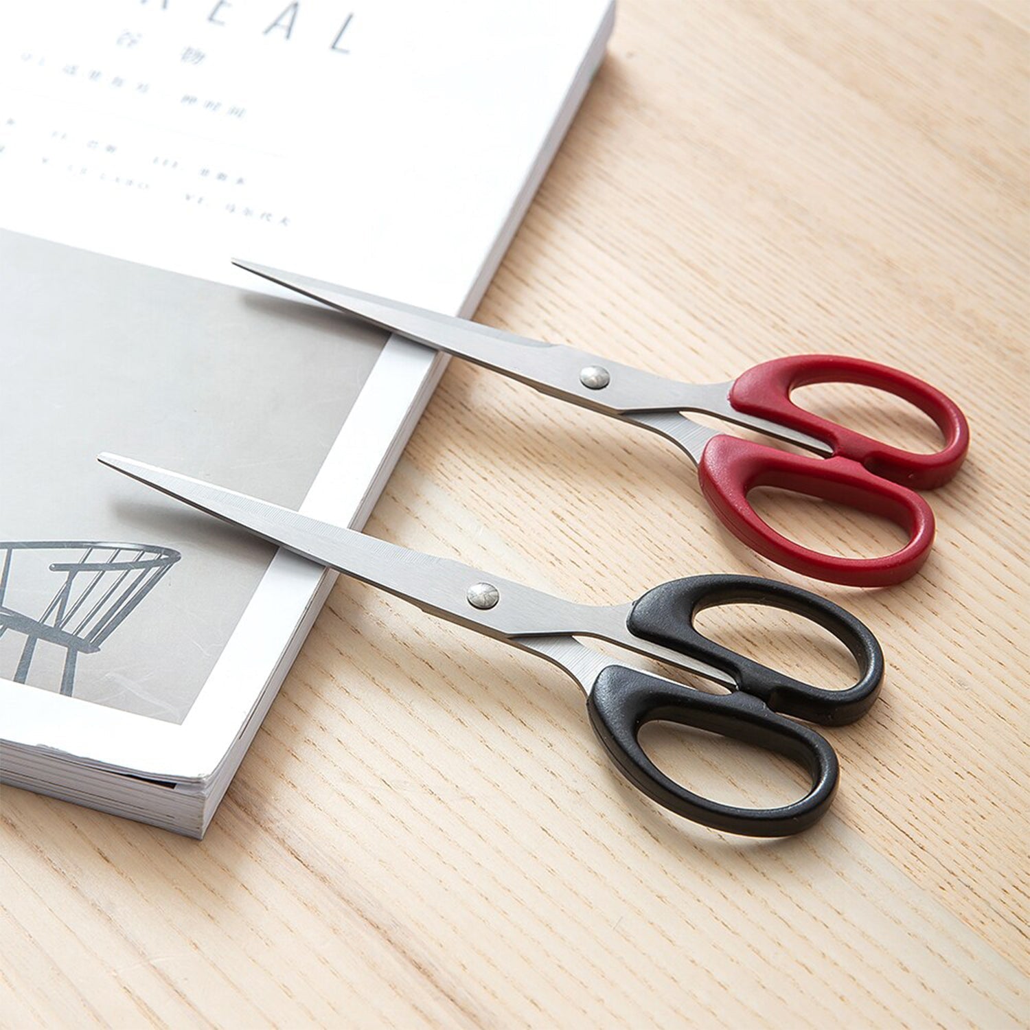 Top-down view of the scissors, emphasizing their stainless steel blades and plastic handle grip Top-down view of the scissors, emphasizing their stainless steel blades and plastic handle grip